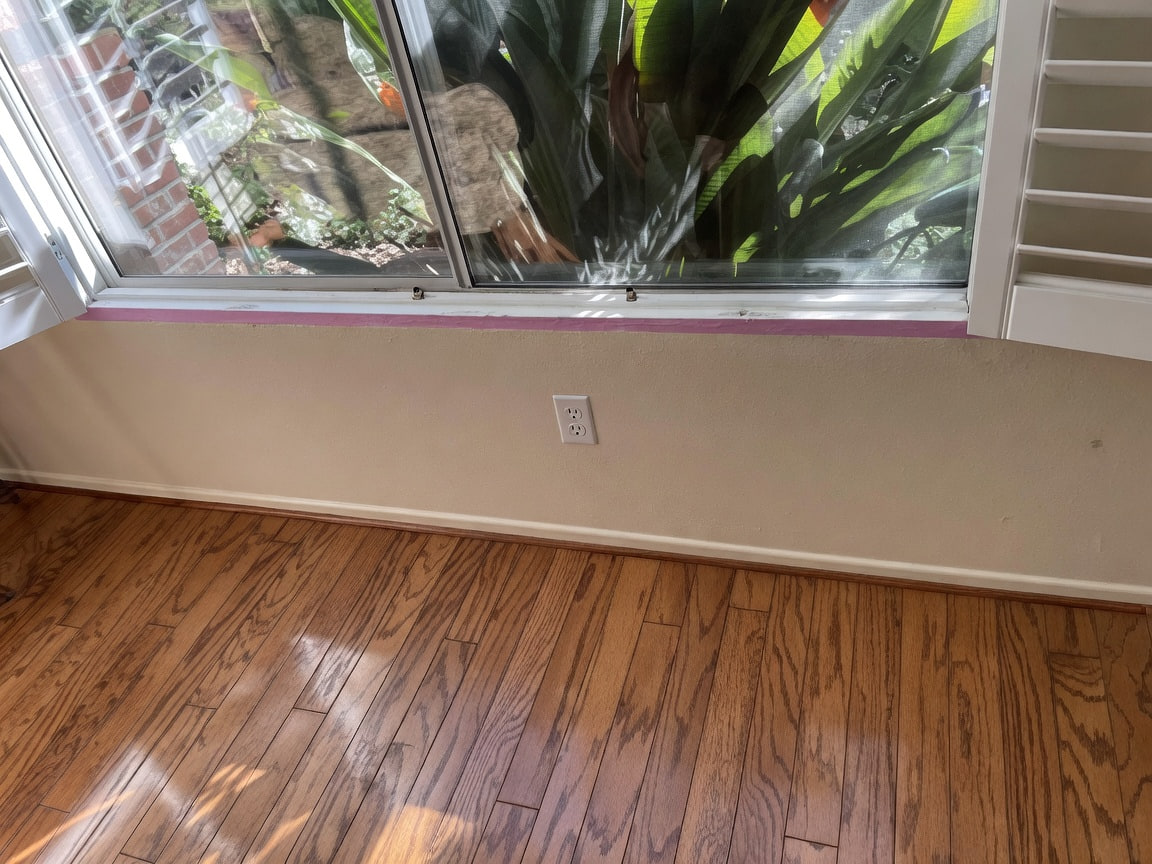 Clean interior walls with hardwood floors after painting